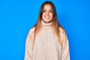 Beautiful caucasian woman wearing wool winter sweater with a happy and cool smile on face. lucky person.