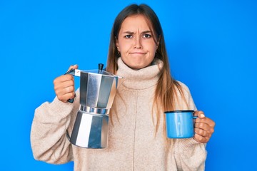 Beautiful caucasian woman drinking italian coffee skeptic and nervous, frowning upset because of problem. negative person.