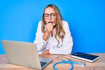 Young beautiful blonde woman wearing doctor uniform working at the clinic feeling unwell and coughing as symptom for cold or bronchitis. health care concept. - obrazy, fototapety, plakaty