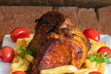 Juicy roast meat on a rustic wooden background.