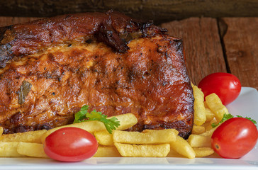 Juicy roast meat on a rustic wooden background.