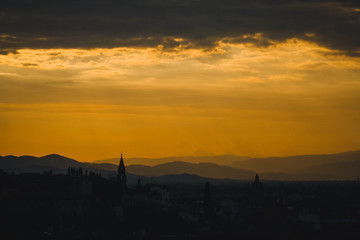 Fototapeta premium Incredible Toscana orange sunset with silhouette of the building