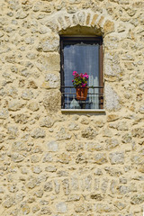 rustic stone house facade with window