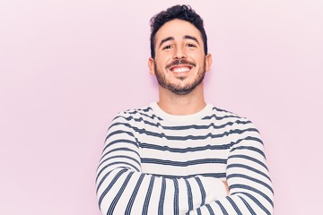 Young hispanic man wearing casual clothes happy face smiling with crossed arms looking at the camera. positive person.