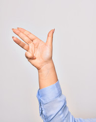 Hand of caucasian young businesswoman doing gun symbol pointing with fingers over isolated white background