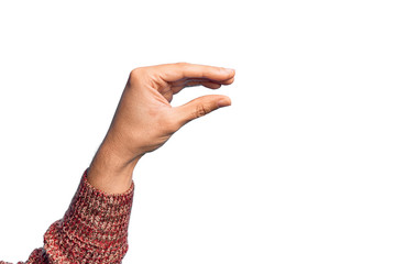 Hand of caucasian young man showing fingers over isolated white background picking and taking invisible thing, holding object with fingers showing space