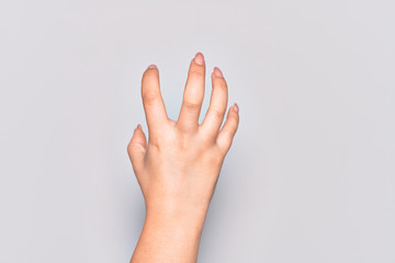 Hand of caucasian young woman grasping aggressive and scary with fingers, violence and frustration
