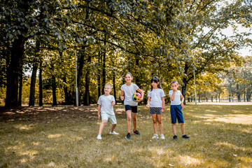 Fototapeta premium School children in white t shirts are playing outside