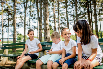 Fototapeta premium School boy with diabetes testing his blood sugar after physical education, friends support him.