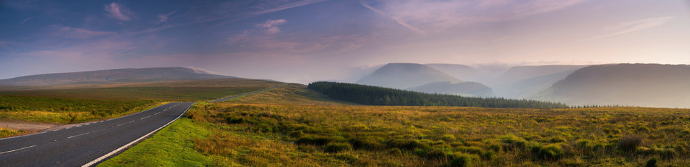 Fototapeta na wymiar The colors of the sunrise. Panorama of Brecon Beacons National Park in Wales.
