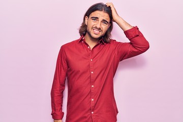 Fototapeta premium Young handsome man wearing business clothes confuse and wonder about question. uncertain with doubt, thinking with hand on head. pensive concept.