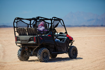 Fototapeta na wymiar riding a buggy car through the desert. thrill tourism adventures