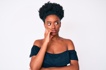 Young african american woman wearing casual clothes looking stressed and nervous with hands on mouth biting nails. anxiety problem.