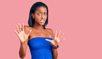 Young african american woman wearing casual summer clothes afraid and terrified with fear...