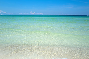 Clouds with blue sky over calm sea beach in tropical beach. Banner or wallpaper for blue sea design, Ocean texture or pattern, summer background.