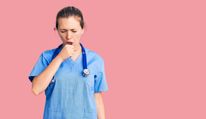 Young beautiful blonde woman wearing doctor uniform and stethoscope feeling unwell and coughing as symptom for cold or bronchitis. health care concept.