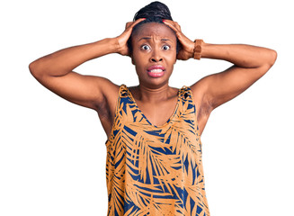 Young african american woman wearing casual clothes crazy and scared with hands on head, afraid and surprised of shock with open mouth