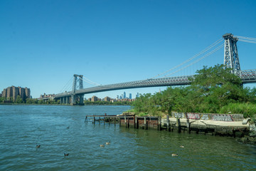 Brooklyn, NY / USA - 8/20/20: Landscape view of Williamsburg Bridge, seen from the Williamsburg South Ferry Landing on the East River.
