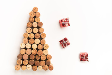 Xmas tree made of wine corks with small gift boxes on white background