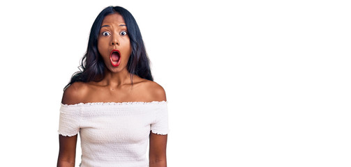 Young indian girl wearing casual clothes scared and amazed with open mouth for surprise, disbelief...