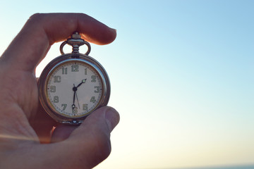 hand holding a clock