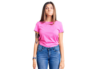 Obraz premium Beautiful caucasian woman wearing casual clothes puffing cheeks with funny face. mouth inflated with air, crazy expression.
