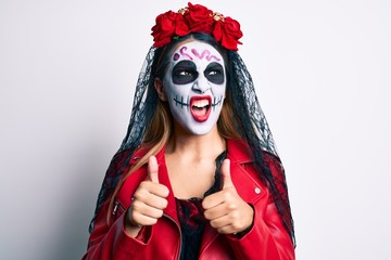 Woman wearing day of the dead costume with thumbs up doing ok sign angry and mad screaming frustrated and furious, shouting with anger. rage and aggressive concept.
