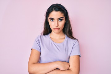 Obraz premium Brunette teenager girl wearing casual clothes skeptic and nervous, disapproving expression on face with crossed arms. negative person.