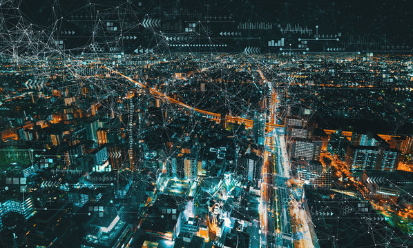 Technology screen with aerial cityscape view of Japan at night - Powered by Adobe