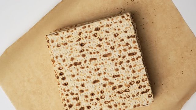  baked square matzah on brown parchment paper, top view. Ingredient for the festive Easter meal of the Seder
