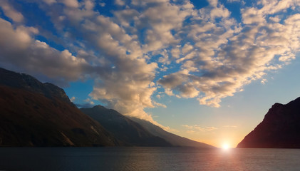 clouds over mountain lake at dawn, sunrise over beautiful mountain lake