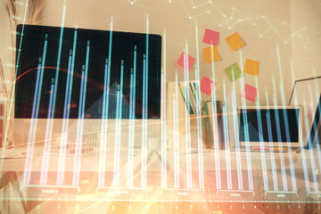 Double exposure of financial graph drawing and office interior background. Concept of stock market.