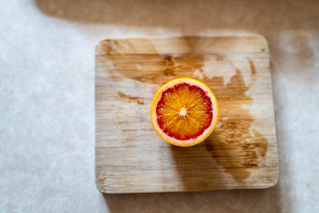 sliced blood orange on wooden board