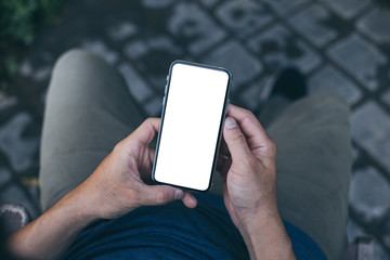 cell phone mockup image blank white screen.man hand holding texting using mobile on desk at coffee...