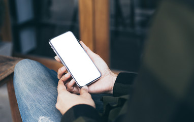 cell phone mockup image blank white screen.woman hand holding texting using mobile on desk at coffee shop.background empty space for advertise.work people contact marketing business,technology
