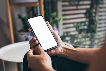 cell phone mockup image blank white screen.woman hand holding texting using mobile on desk at coffee shop.background empty space for advertise.work people contact marketing business,technology