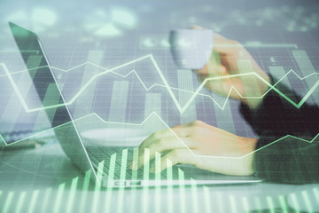 Double exposure of businesswoman hands typing on computer and forex graph hologram drawing. Financial analysis concept.