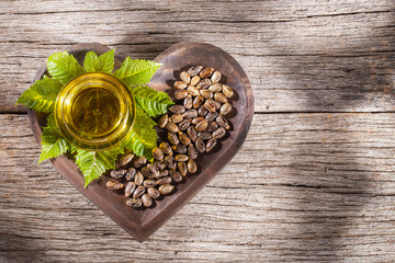 castor oil and seeds, on wooden background © Alexander Ruiz