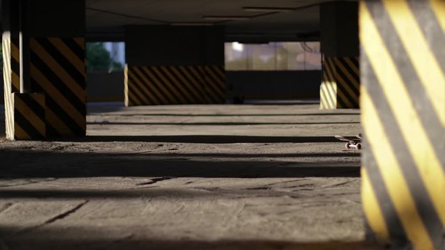 Scater riding a scateboard in an empty garage. Scater boy. Extreme sport.