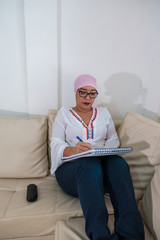 Hispanic Woman with breast cancer writing