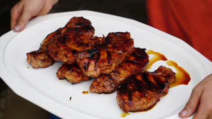 Grilled pork chops on a white plate