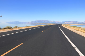 Antelope Island Causeway across the Great Salt Lake towards Wasatch Mountain Range in the East
