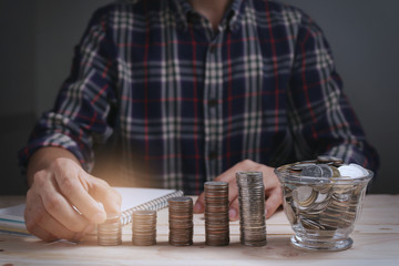 Man holding coin with concept saving money for finance accounting with growing business