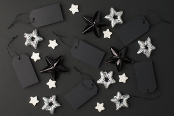 New Year 20202, Christmas Holiday seasonal sale - tags with copy space and stars decorations on balck background. Monochrome stylish luxury concept, banner, voucher for shopping