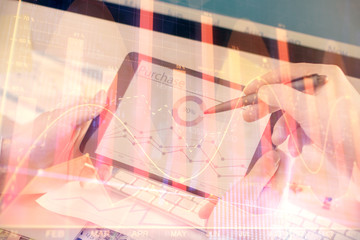 Double exposure of man's hands holding and using a phone and financial chart drawing. Market analysis concept.