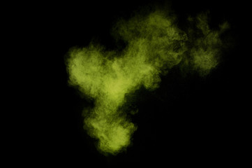 Fototapeta na wymiar Light green powder explosion on black background. Colored powder cloud. Colorful dust explode. Paint Holi.