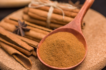 Cinnamon bark and hammer and biscuits. wooden table