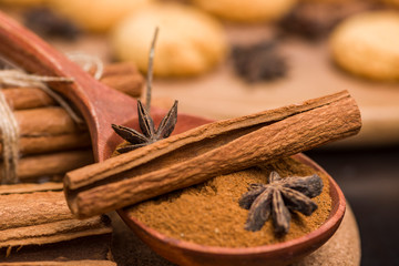 Cinnamon bark and hammer and biscuits. wooden table