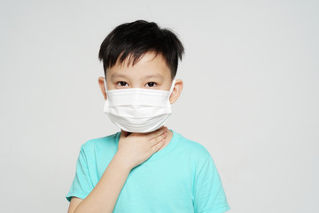 young boy with face mask posing sore throat 