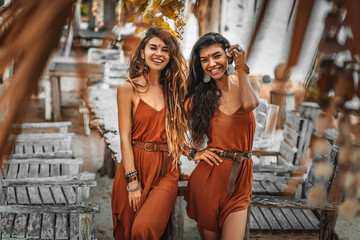 Two beautiful young stylish fashion models having fun outdoors